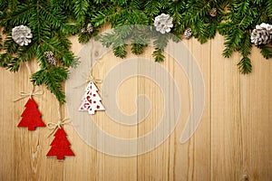 Christmas background with firtree, decorative trees and cones on