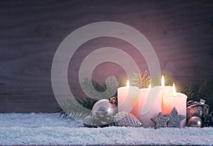 Four pink burning advent candles. Christmas card.