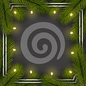 Christmas background. Frame of Christmas tree branches. With a garland of lights.