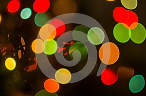 Christmas background-garlands with colorful lights on a decorated Christmas tree, bokeh, blurred