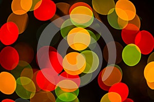 Christmas background-garlands with colorful lights on a decorated Christmas tree, bokeh, blurred