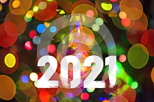 Christmas background-garlands with colorful lights on a decorated Christmas tree, bokeh, Happy New Year 2021 colored