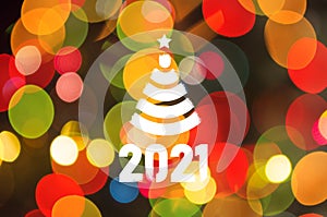 Christmas background-garlands with colorful lights on a decorated Christmas tree, bokeh, Happy New Year 2021 colored symbol and