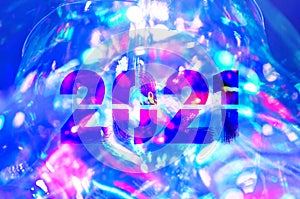 Christmas background-garlands with colorful lights on a decorated Christmas tree, bokeh, Happy New Year 2021 colored symbol and