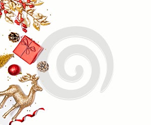 Christmas background - gift box, mistletoe, fircones,reindeer and christmas balls in golden and red colors over white background.