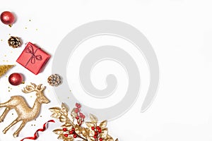 Christmas background - gift box, mistletoe, fircones,reindeer and christmas balls in golden and red colors over white background.