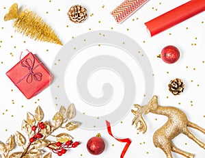Christmas background - gift box, mistletoe, fircones,reindeer and christmas balls in golden and red colors over white background
