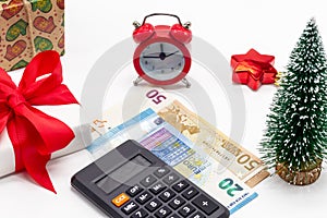 Christmas background with gift boxes, alarm clock, 50 and 20 euro money and calculator. It`s time to buy gifts. The festive