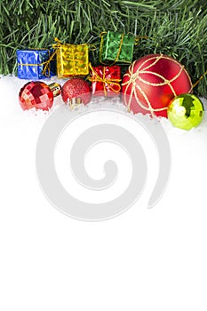 Christmas background with gift boxes and balls on snow