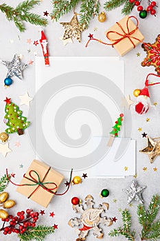 Christmas background with gift boxes, festive decor, fir tree branches and paper cards notes. Flat lay