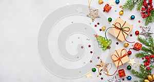 Christmas background with gift boxes, festive decor, fir tree branches and paper cards notes. Flat lay