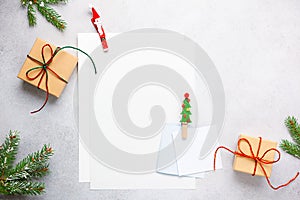 Christmas background with gift boxes, festive decor, fir tree branches and paper cards notes. Flat lay