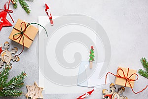 Christmas background with gift boxes, festive decor, fir tree branches and paper cards notes. Flat lay