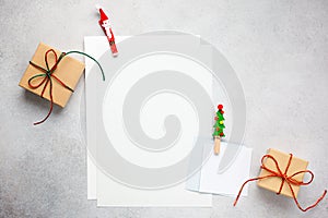 Christmas background with gift boxes, festive decor and paper cards notes. Flat lay. Christmas and New Year concept