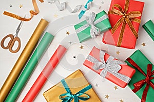 Christmas background with gift boxes and rolls of kraft wrapping paper