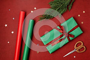 Christmas background with gift boxes and rolls of kraft wrapping paper