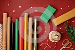 Christmas background with gift boxes and rolls of kraft wrapping paper