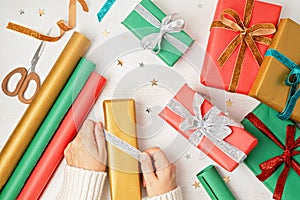 Christmas background with gift boxes and rolls of kraft wrapping paper