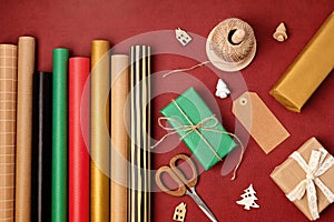 Christmas background with gift boxes and rolls of kraft wrapping paper