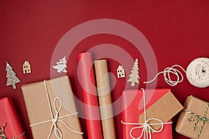 Christmas background with gift boxes and rolls of kraft wrapping paper