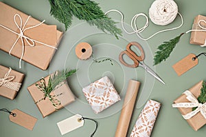 Christmas background with gift boxes and rolls of kraft wrapping paper