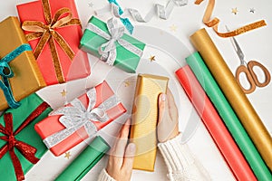 Christmas background with gift boxes and rolls of kraft wrapping paper