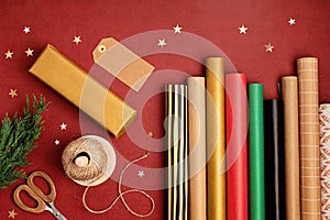 Christmas background with gift boxes and rolls of kraft wrapping paper