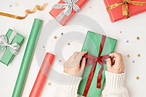 Christmas background with gift boxes and rolls of kraft wrapping paper