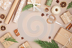 Christmas background with gift boxes and rolls of kraft wrapping paper