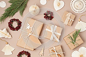 Christmas background with gift boxes and rolls of kraft wrapping paper