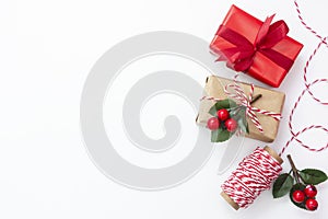 Christmas background. Gift boxes wraped in craft paper over white background. Wraping gift boxes. Top view. Copy space