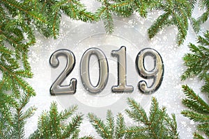Christmas background with gift, Christmas tree and numbers 2019 on white wooden table.