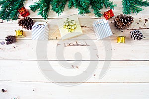 Christmas background with gift and christmas Decoration , christmas tree and pine cones on wooden table. Top view with copy space