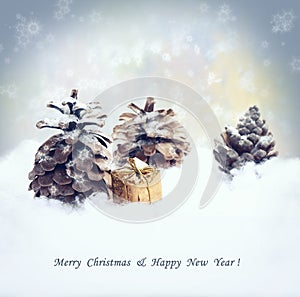 Christmas background with gift, fir tree cone, snowfall.