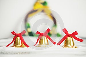 Christmas background, golden bells with red ribbon