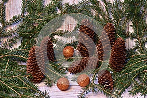 Christmas background of green spruce branches with cones and new year decorations