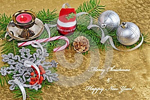 Christmas background greeting card with baubles, gift, fir and decorations over golden background