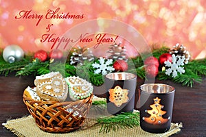 Christmas background, greeting card with burning candle and gingerbread cookies