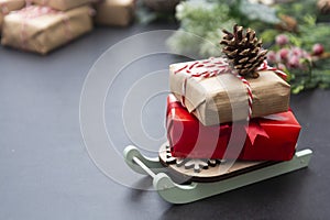 Christmas background or greeting cards, mock up with gift boxes on sleigh over gray background. Winter holidays. Copy space