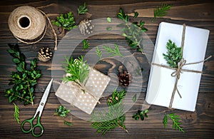 Christmas background with hand crafted gifts, presents on rustic wooden table. Christmas DIY packing. Overhead, flat lay, top view