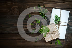 Christmas background with hand crafted gifts, presents on rustic wooden table. Overhead, flat lay, top view, copy space photo
