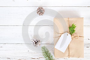 Christmas background with handmade present gift boxes and rustic decoration on white wooden board.
