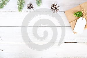 Christmas background with handmade present gift boxes and rustic decoration on white wooden board