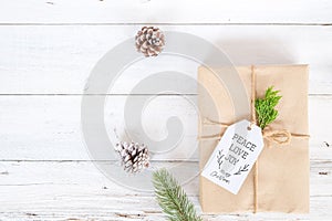 Christmas background with handmade present gift boxes and rustic decoration on white wooden board.