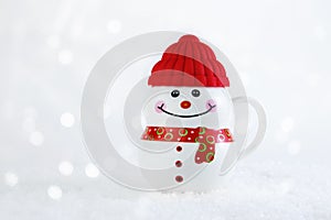 Christmas background. Happy snowman standing in winter christmas landscape. Merry christmas and happy new year greeting card. Mug