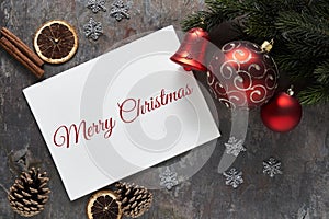 Christmas background with holiday festive decorations and Merry Christmas text on dark background