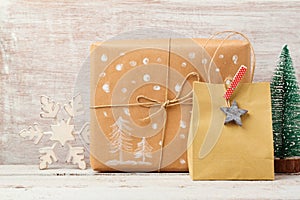 Christmas background with homemade gift bag, box and rustic decorations