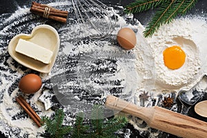 Christmas background with ingredients for baking on a black concrete background. Top view, copy space,flat lay