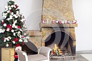 Christmas background interior of a warm house with a decorated Christmas tree and a burning fireplace fire. Cozy festive interior