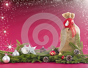 Christmas background with jute sack, fir branches and cones.